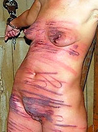 Extreme caning of masochist woman till red marks and bruises