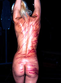 Public punishment of blonde masochist in the San Francisco BDSM Dungeon